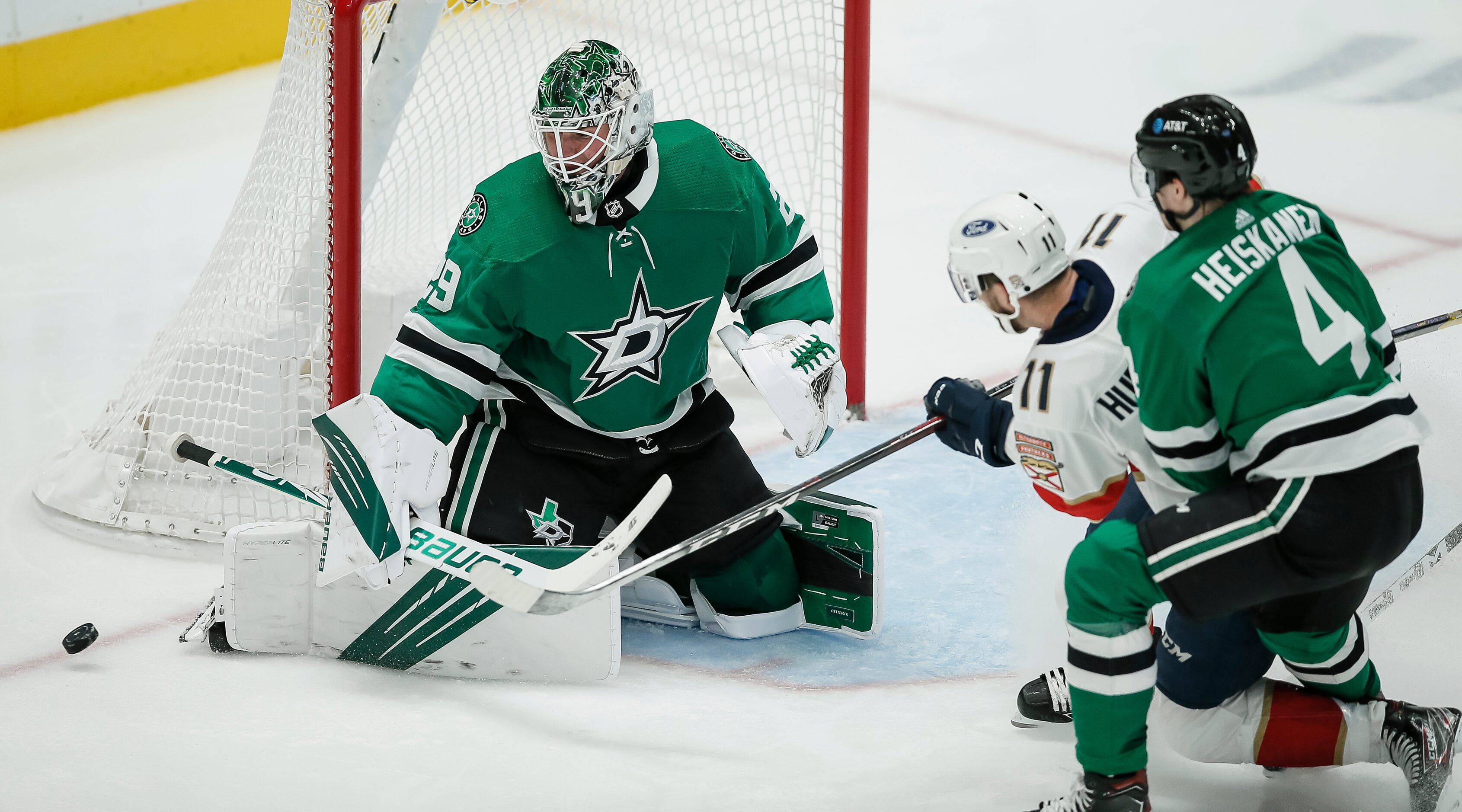 Dallas Stars goaltender Jake Oettinger (29) deflects a shot from Florida Panthers forward...