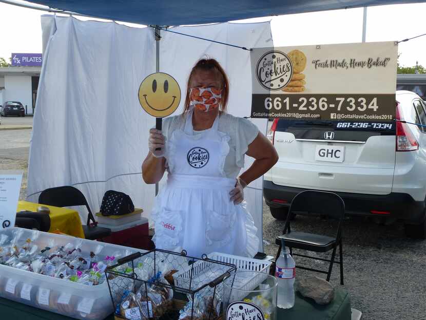Debbie Zess has a COVID-era smile for everyone at her Gotta Have Cookies table at Cowtown...