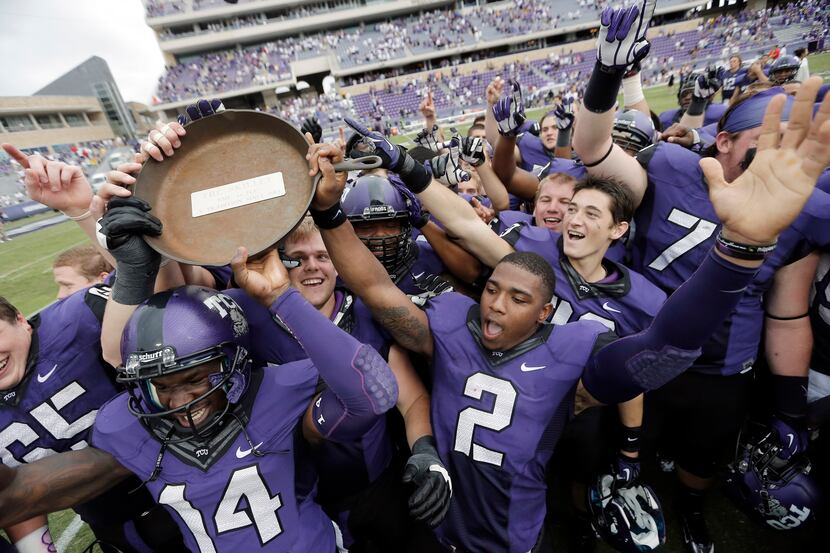 TCU quarterback Trevone Boykin (2) and his teammates celebrate with the Iron Skillet after...