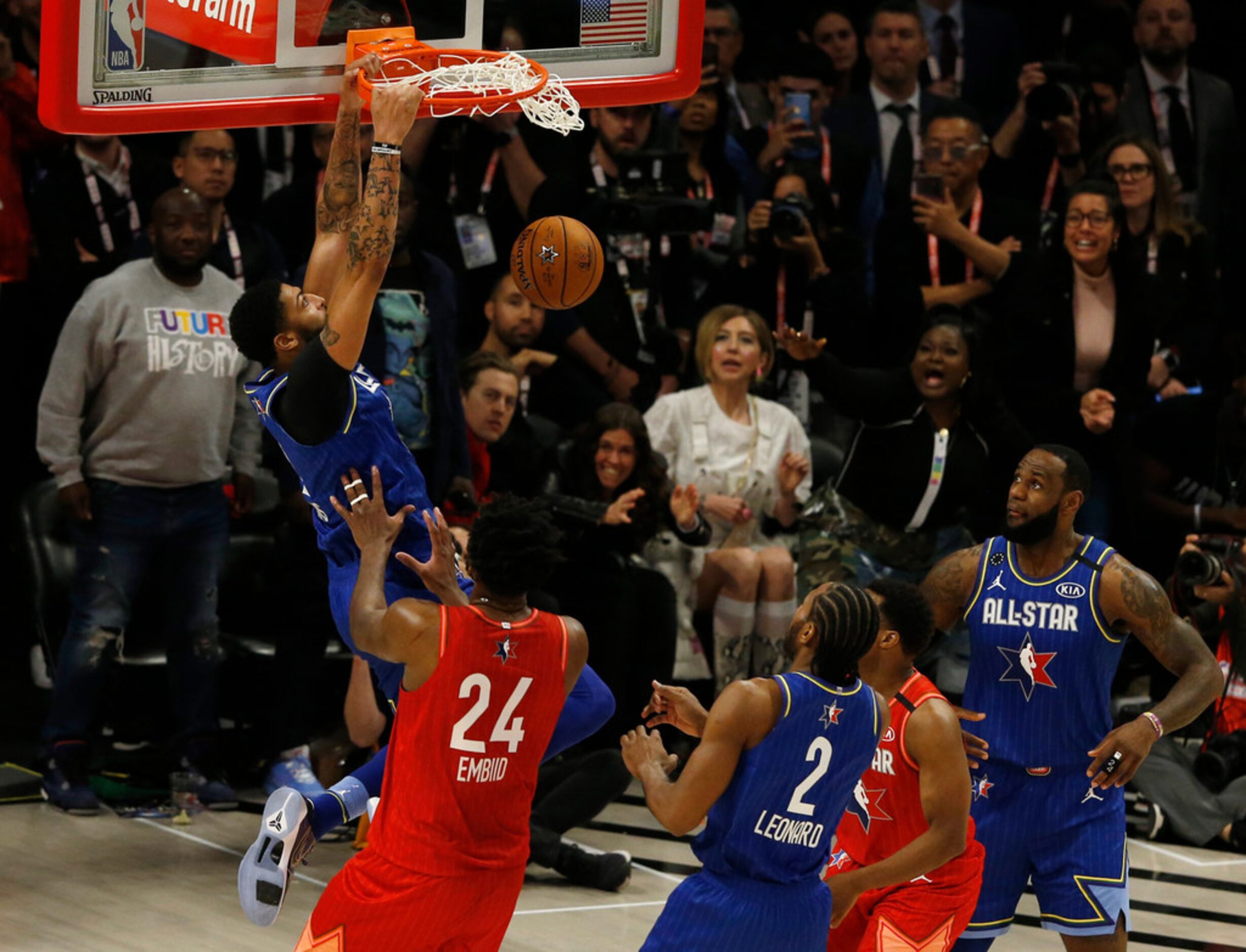 Team LeBron's Anthony Davis (2) dunks in front of Team Giannis' Joel Embiid (24) during the...