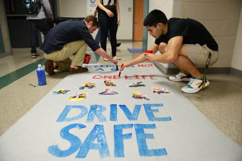 
Chase Darden (left) and Jacob Ruse paint a poster during Suzanne Reese's leadership class,...
