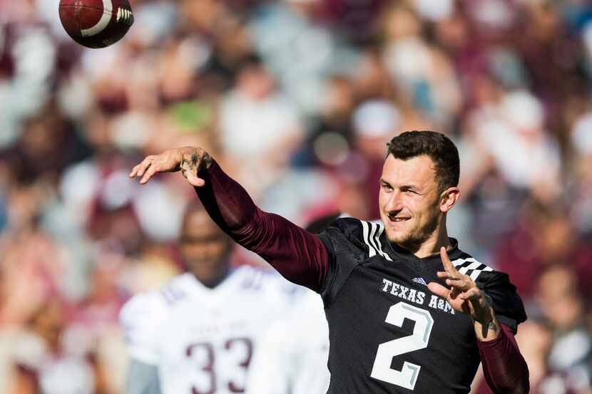 FILE - Former Texas A&M Aggies quarterback Johnny Manziel throws a pass to other former...