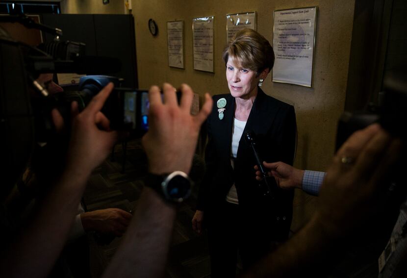 Former Dallas Mayor Laura Miller speaks to reporters as she leaves the city secretary's...