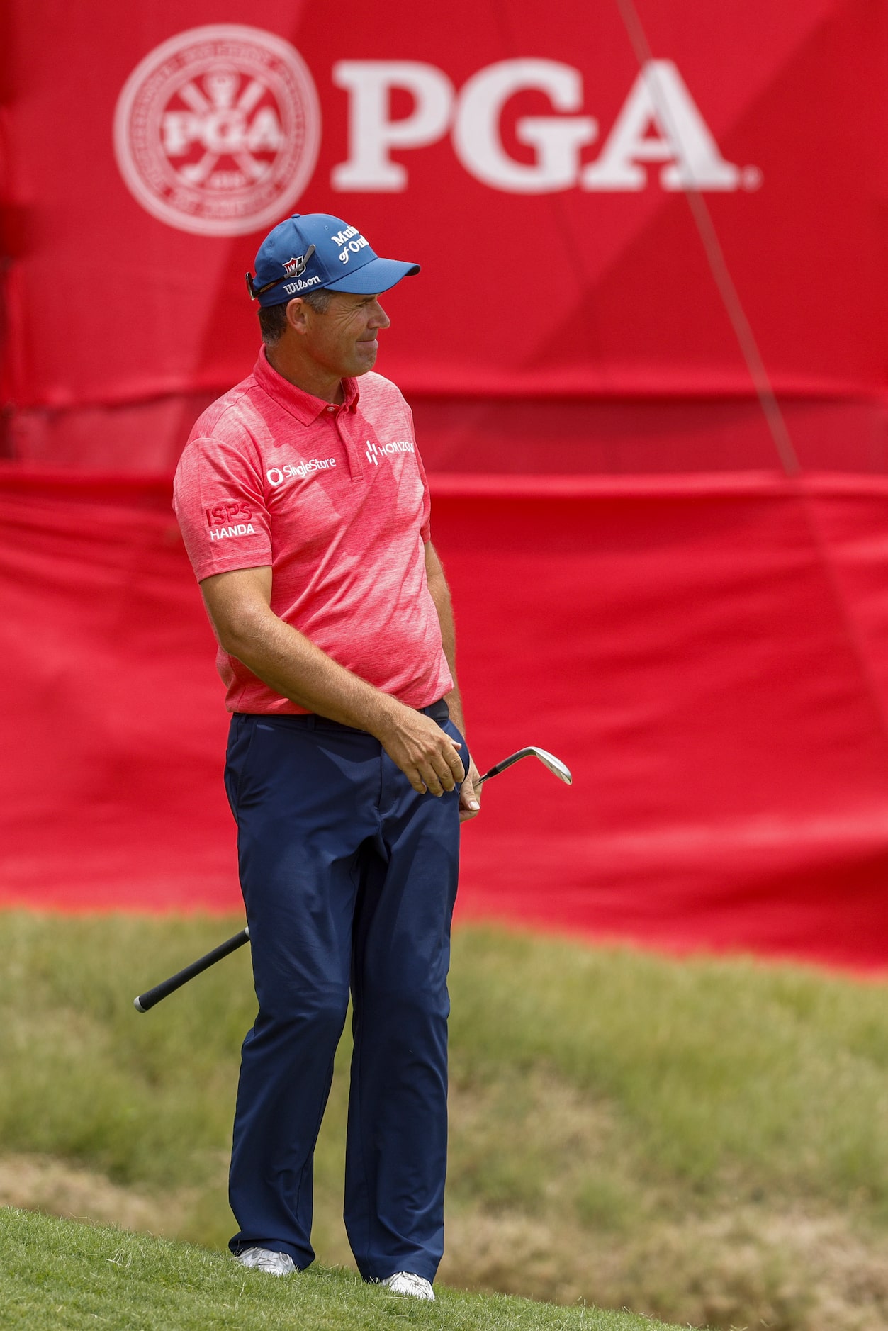 Padraig Harrington of Ireland watches his chip shot on the 18th green during the first round...