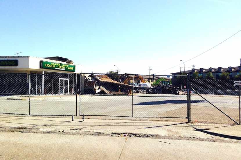  Demolition crews are knocking down an old shopping center, apartments and other buildings...