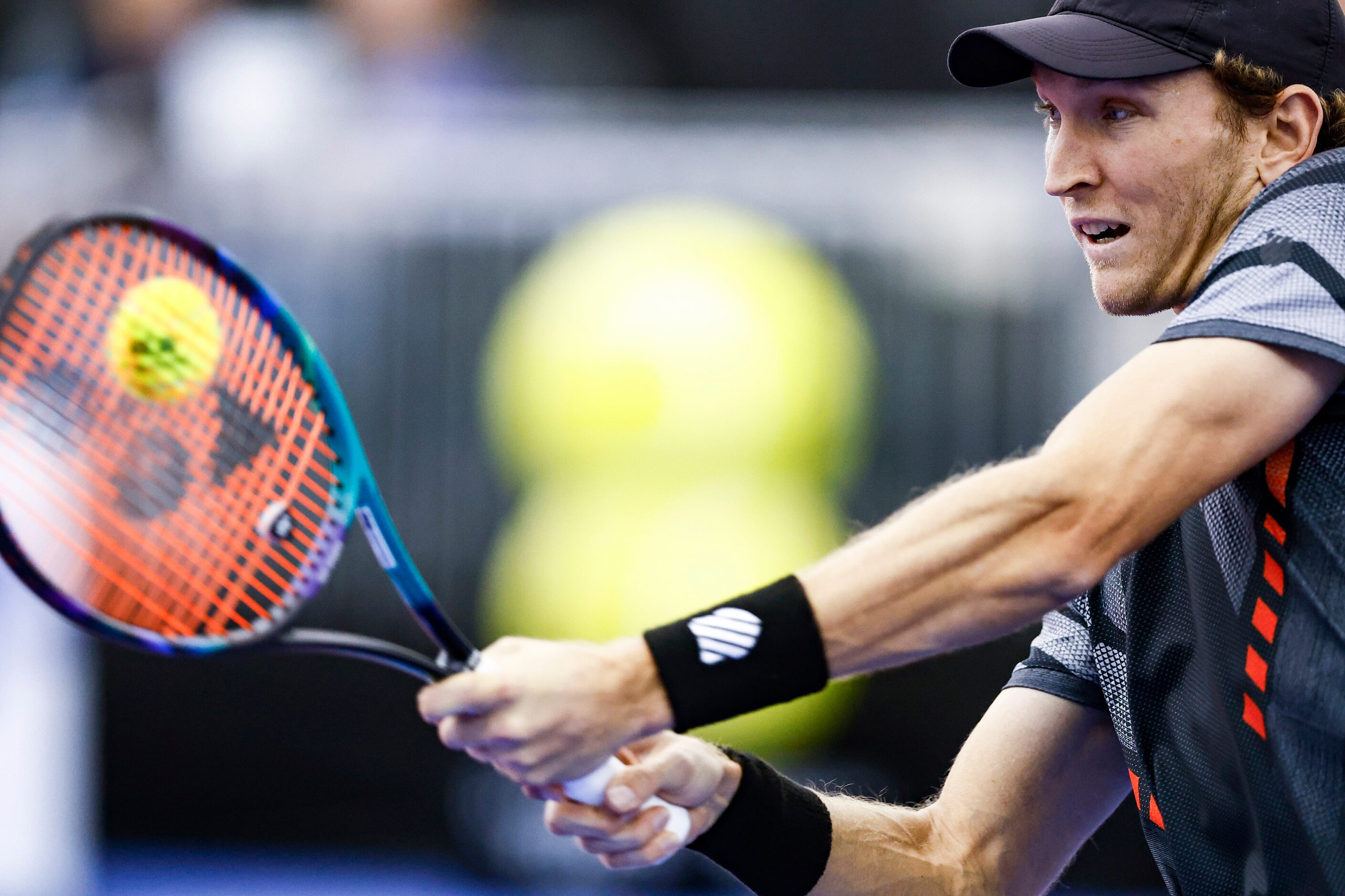 Mitchell Krueger, a Fort Worth native, returns the ball in a match against Yoshihito...