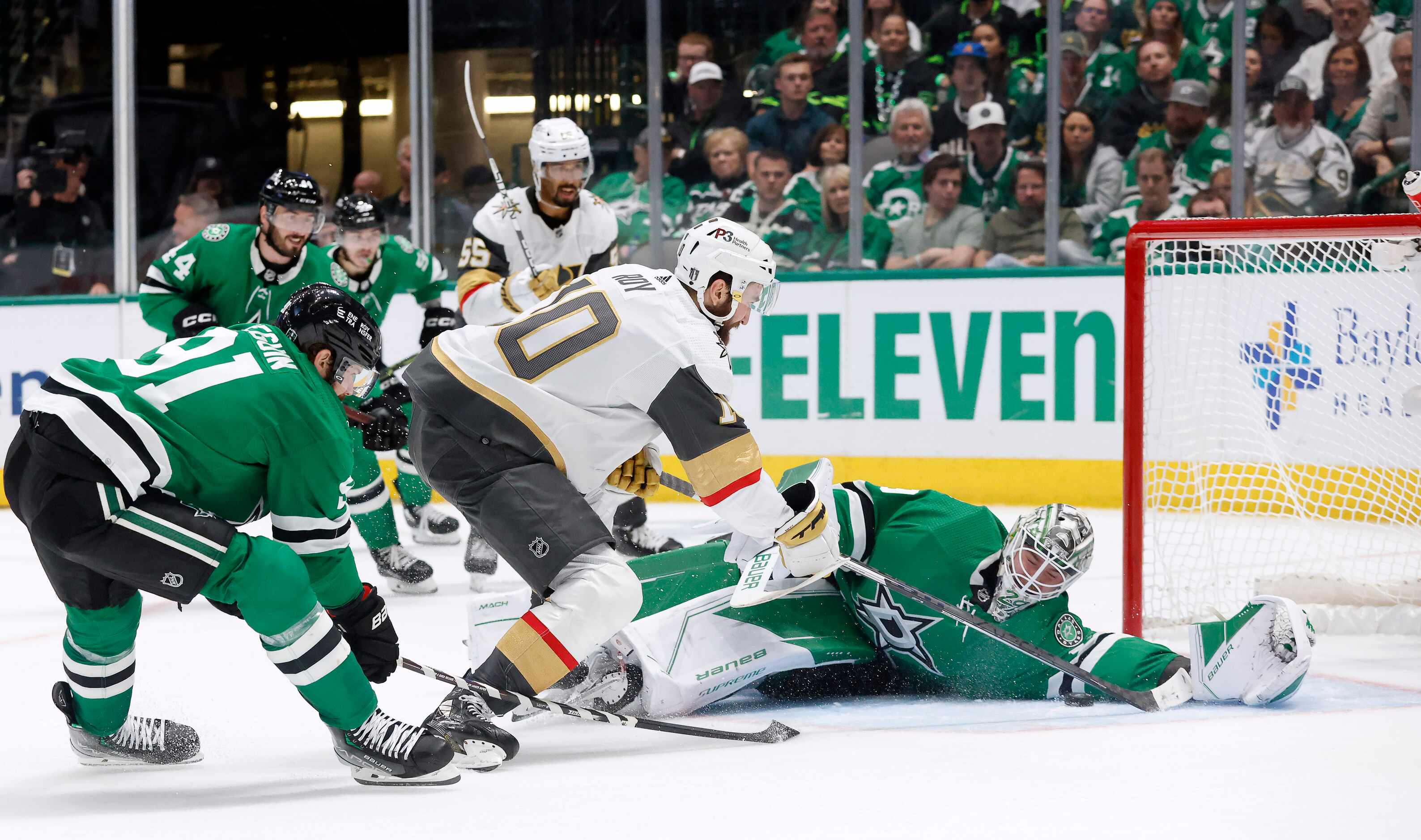 Dallas Stars goaltender Jake Oettinger (29) lays out to save a shot by Vegas Golden Knights...