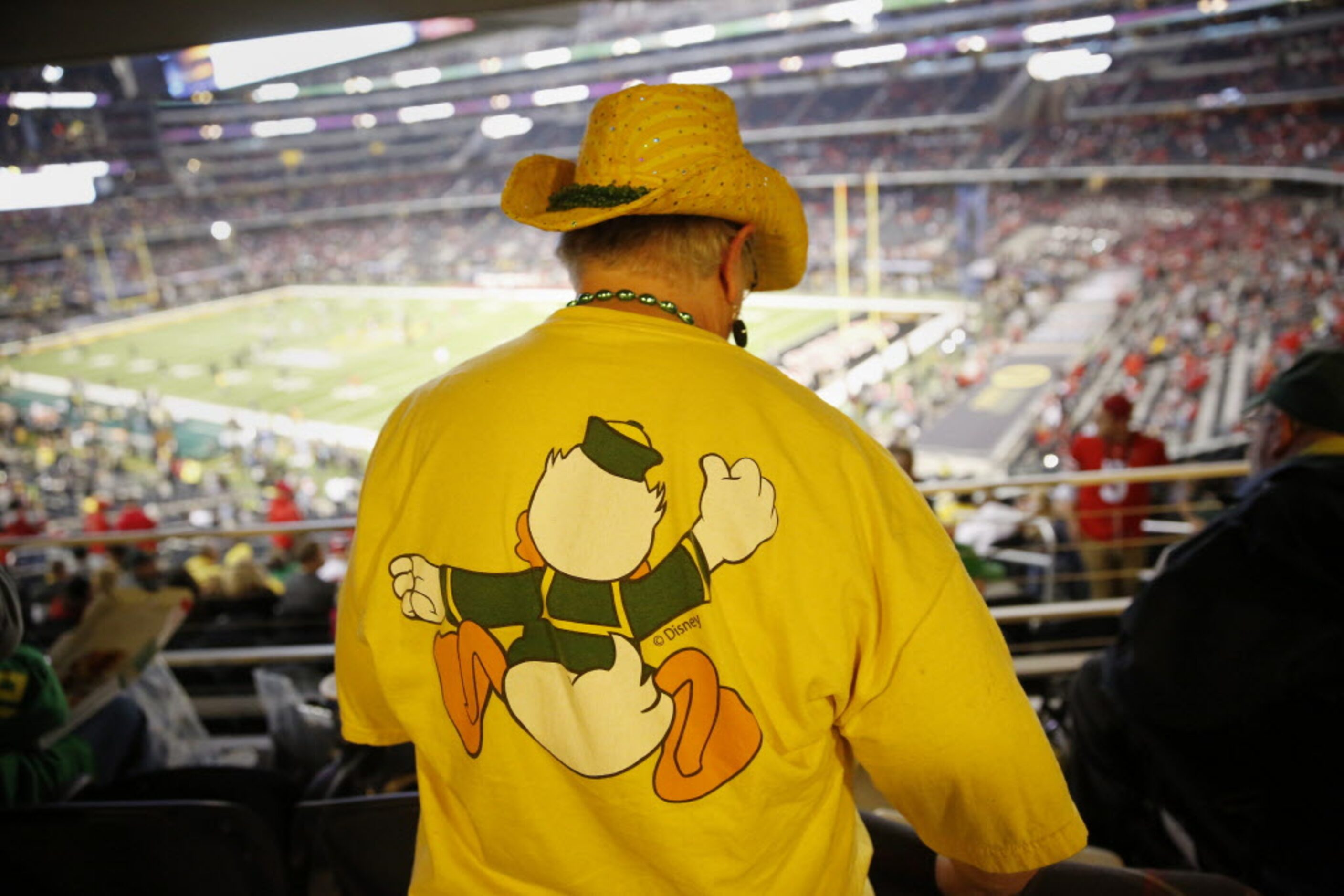 Oregon Ducks fan Lynn Uchison (left), of Enterprise, Oregon, looks for her seat before the...