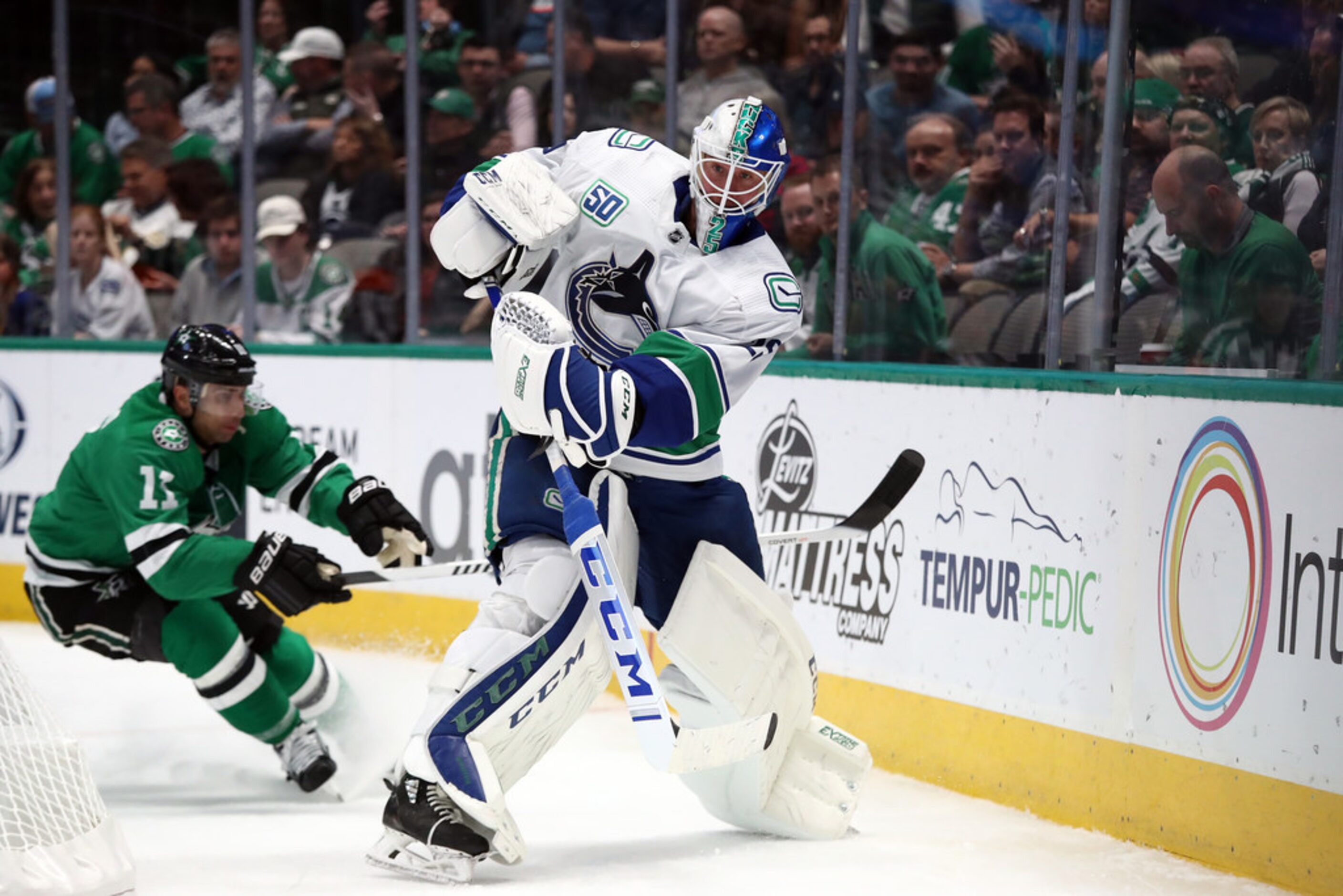 DALLAS, TEXAS - NOVEMBER 19:  Jacob Markstrom #25 of the Vancouver Canucks plays the puck...