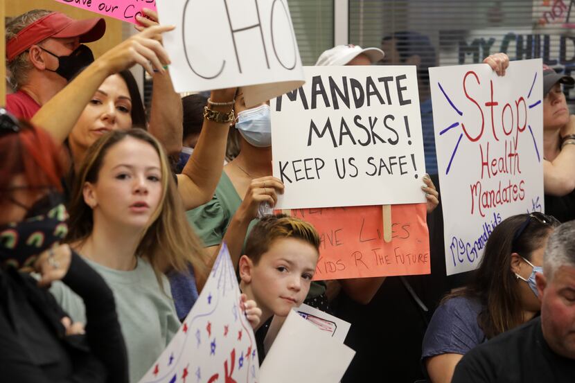 Community members packed an emergency meeting of the Plano ISD school board regarding mask...