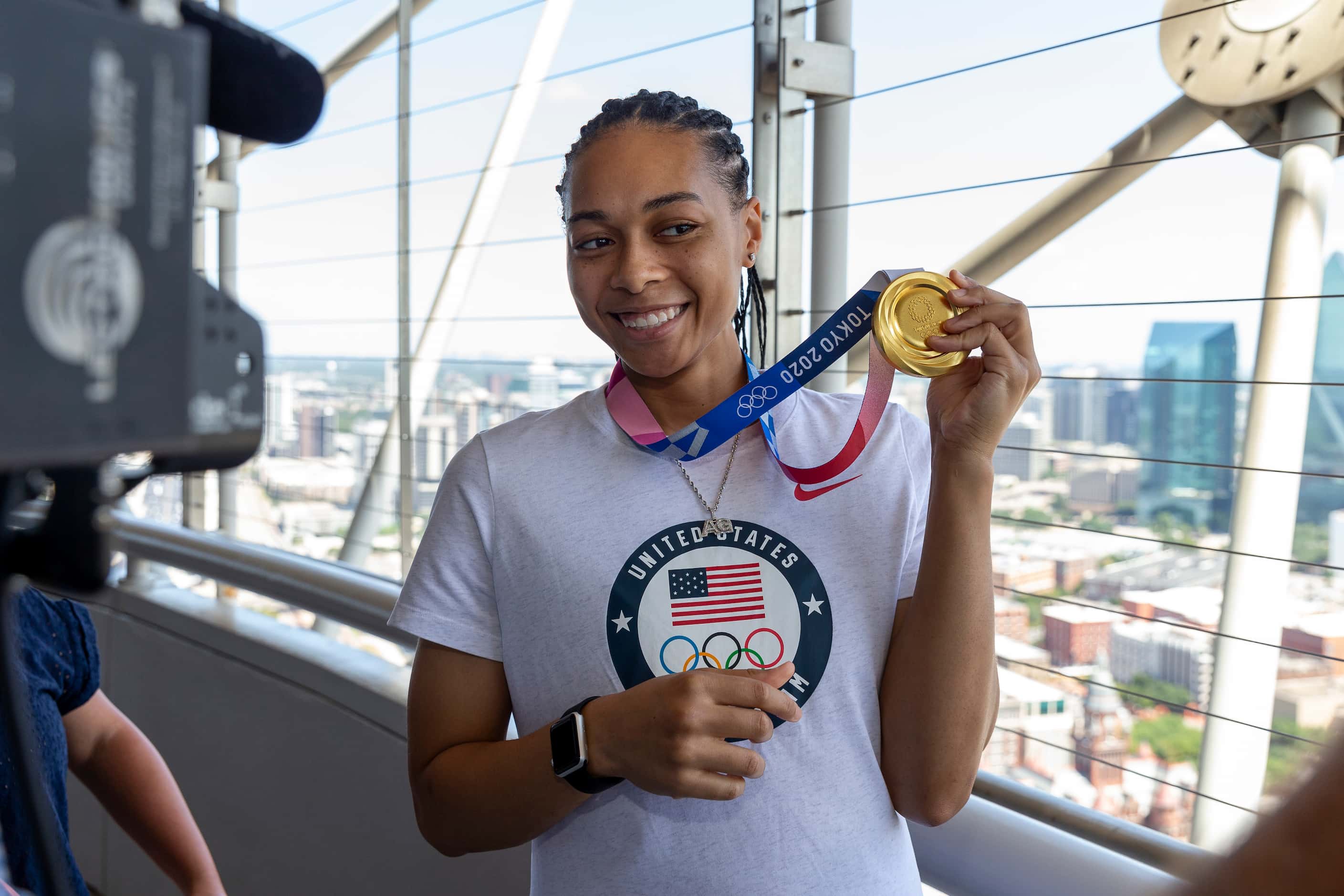 Allisha Gray, Olympic gold medalist and Dallas Wings guard, shows off her gold medal during...