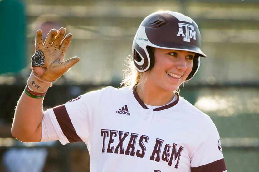 Texas A&M outfielder Sarah Hudek smiles after advancing to third base during an NCAA...