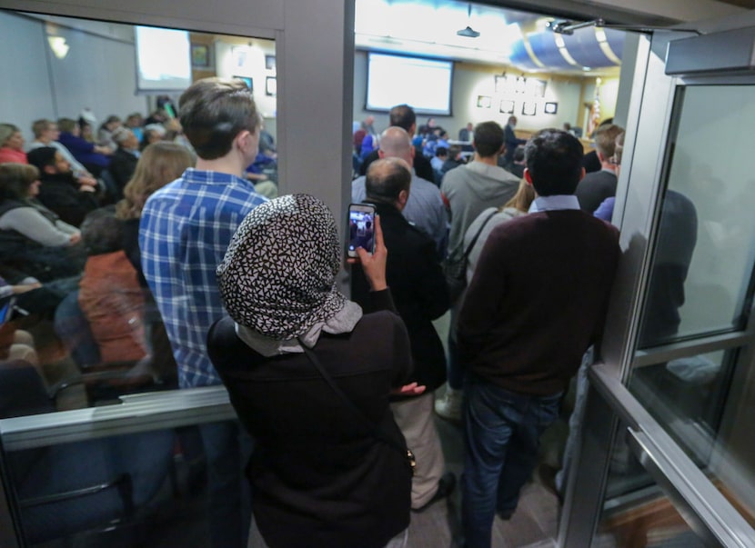 Ayesha Uddin, left, records one of the speakers at the McKinney ISD school board meeting on...