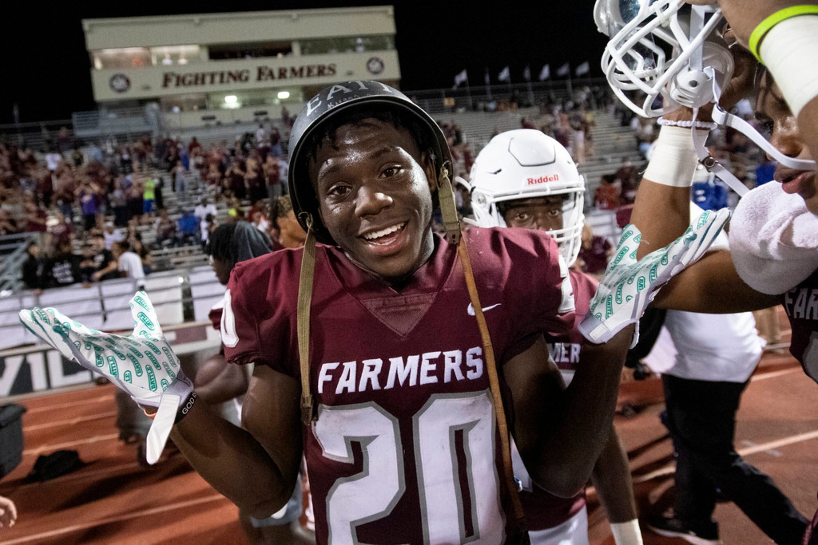 Lewisville junior Keegan Brewer (20), who recovered a fumble in the first half, mugs for the...