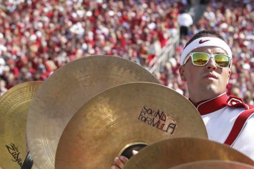 
OU band member Chance Pruitt plays the cymbals during the Red River Rivalry game between...