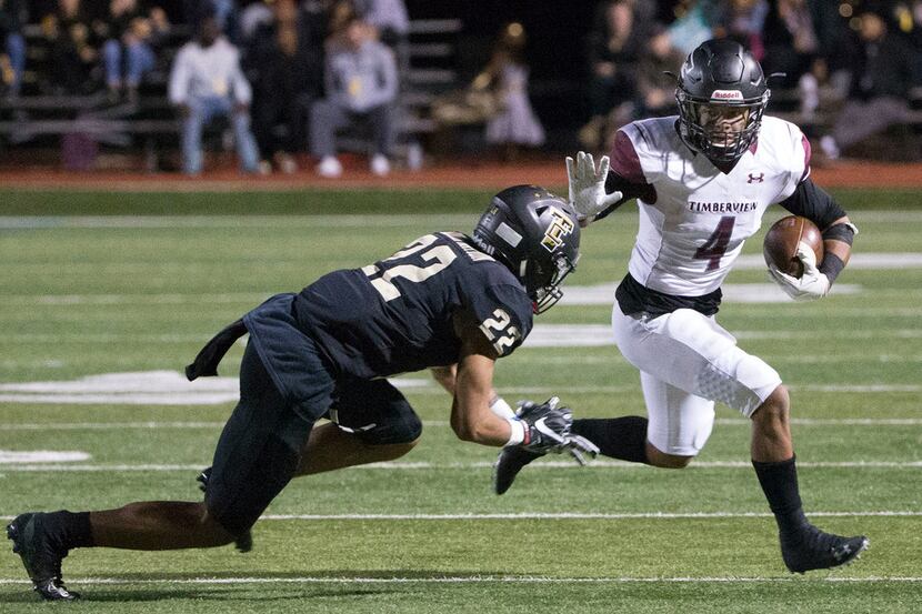 Mansfield Timberview running back Montaye Dawson (4) attempts to stiff-arm The Colony's...