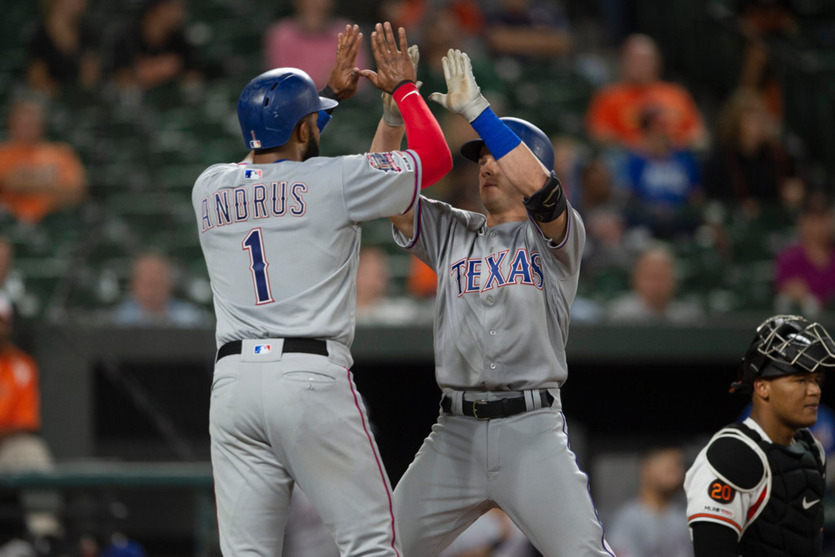 Texas Rangers' Nick Solak celebrates with Elvis Andrus (1) at home plate after hitting a two...