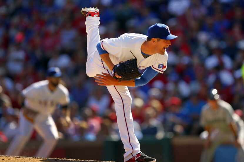 Texas Rangers starting pitcher Cole Hamels (35) follows through on a pitch against the...