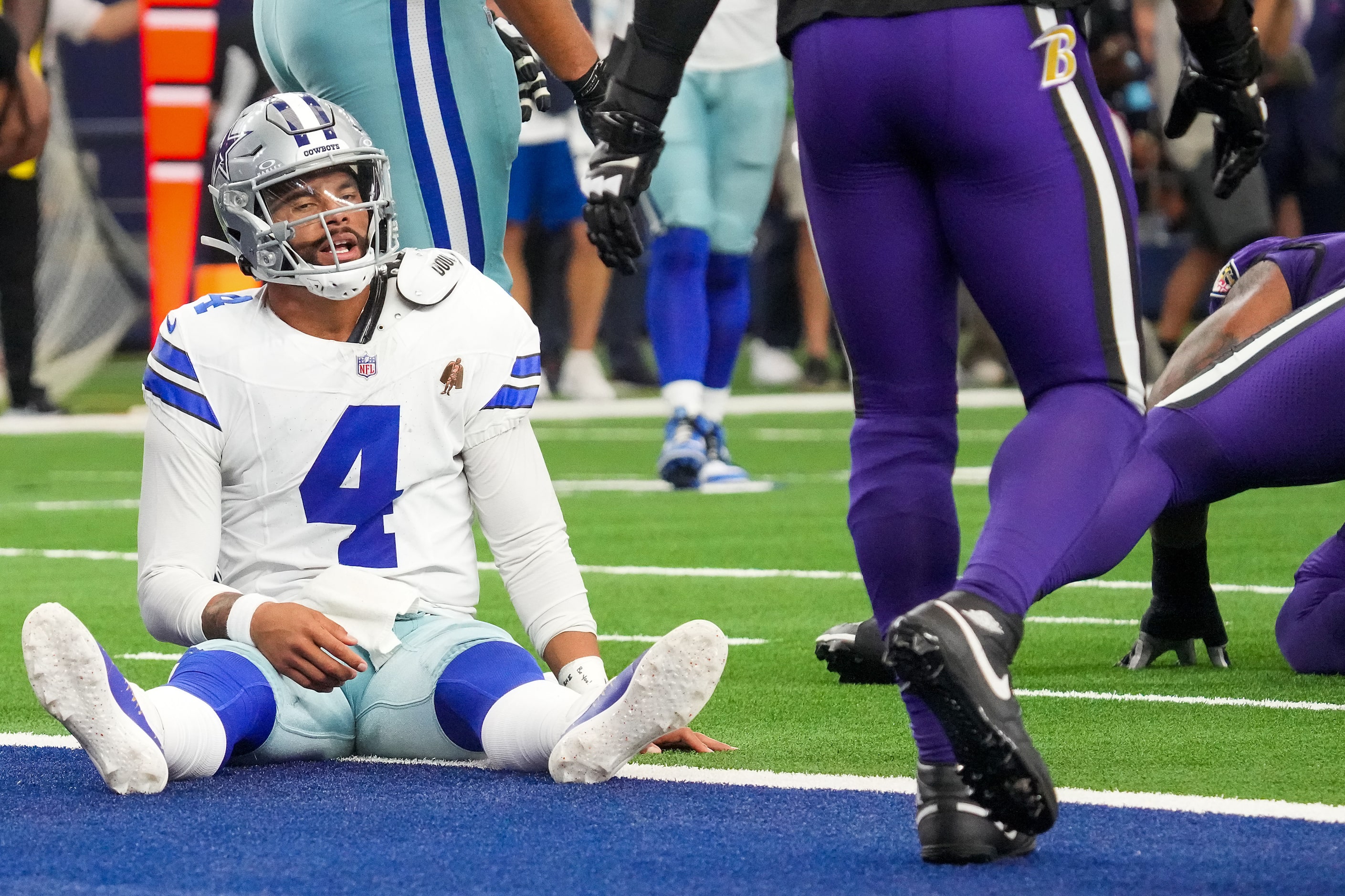 Dallas Cowboys quarterback Dak Prescott reacts after he barely got off a pass before being...