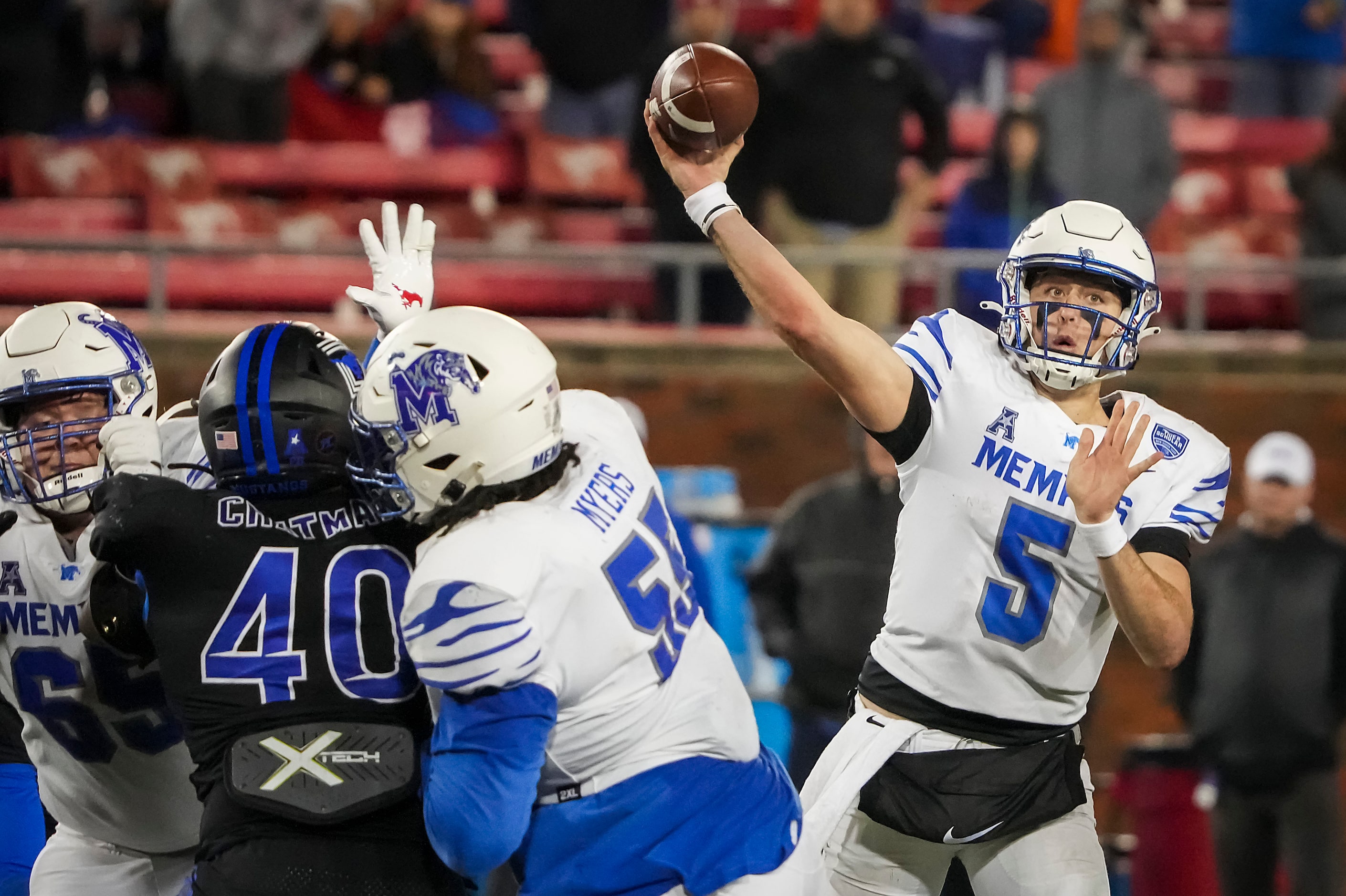 Memphis quarterback Seth Henigan (5) throws a pass as offensive lineman Austin Myers (55)...