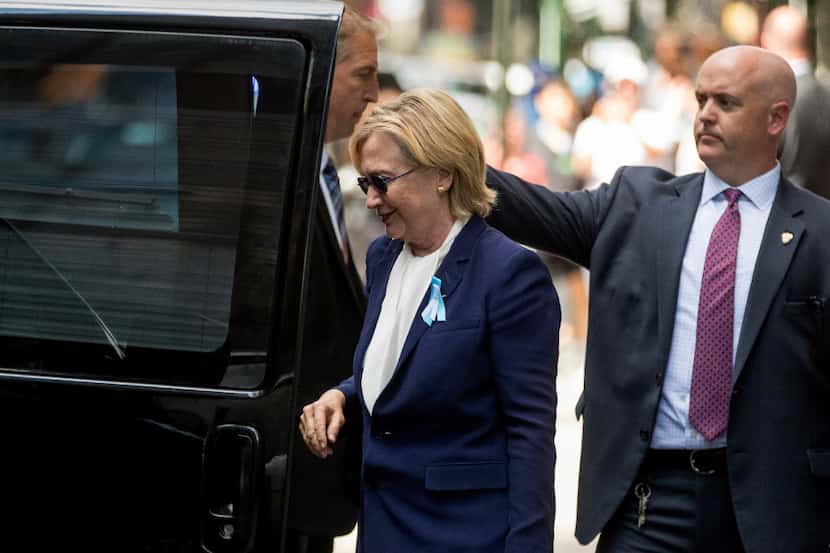 Democratic presidential candidate Hillary Clinton gets into a van as she leaves an apartment...