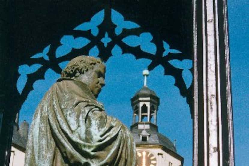 A statue in Wittenberg's market square depicts Martin Luther with a copy of the New...