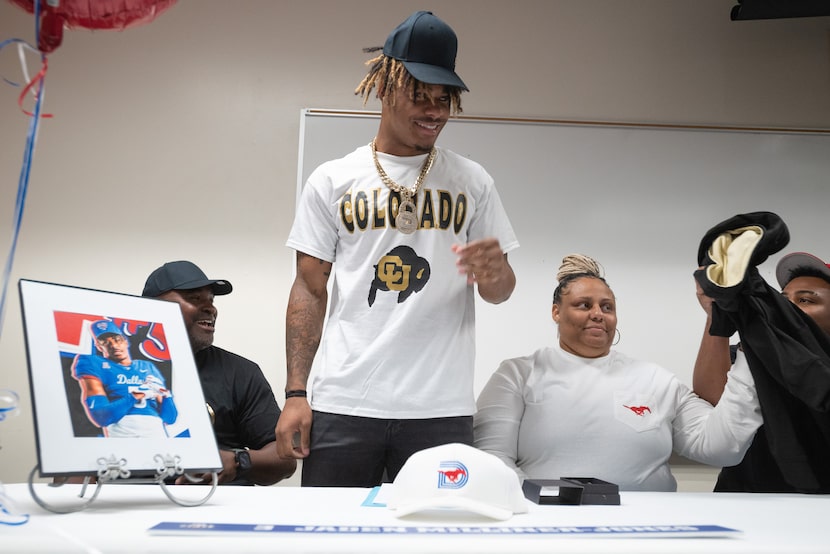 DeSoto high school football player Jaden Milliner-Jones shows off his Colorado merchandise...