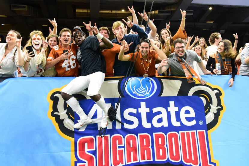 IMAGE DISTRIBUTED FOR ALLSTATE - University of Texas fans celebrate their victory with...