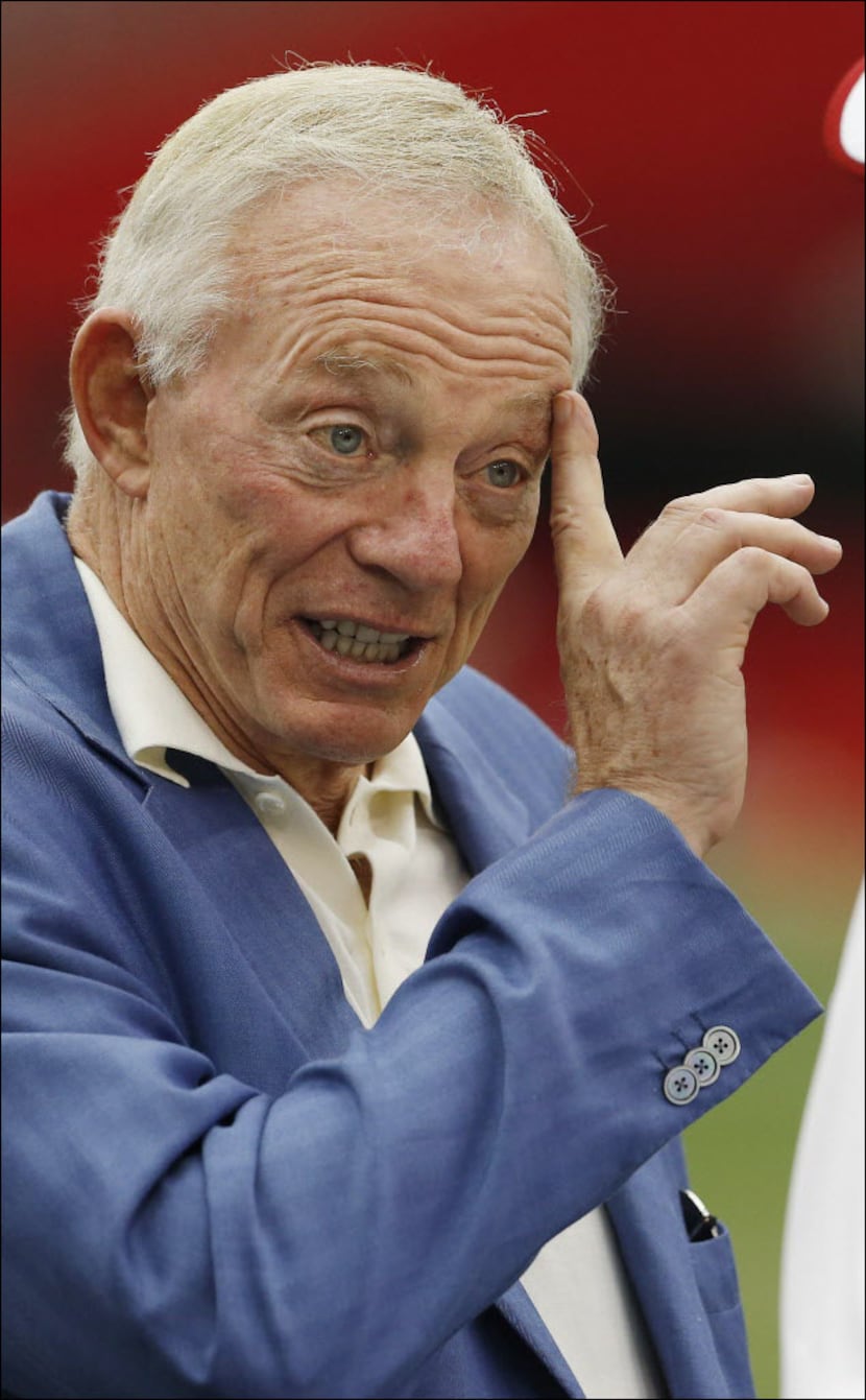 Dallas Cowboys owner Jerry Jones talks with a coach prior to a preseason NFL football game...