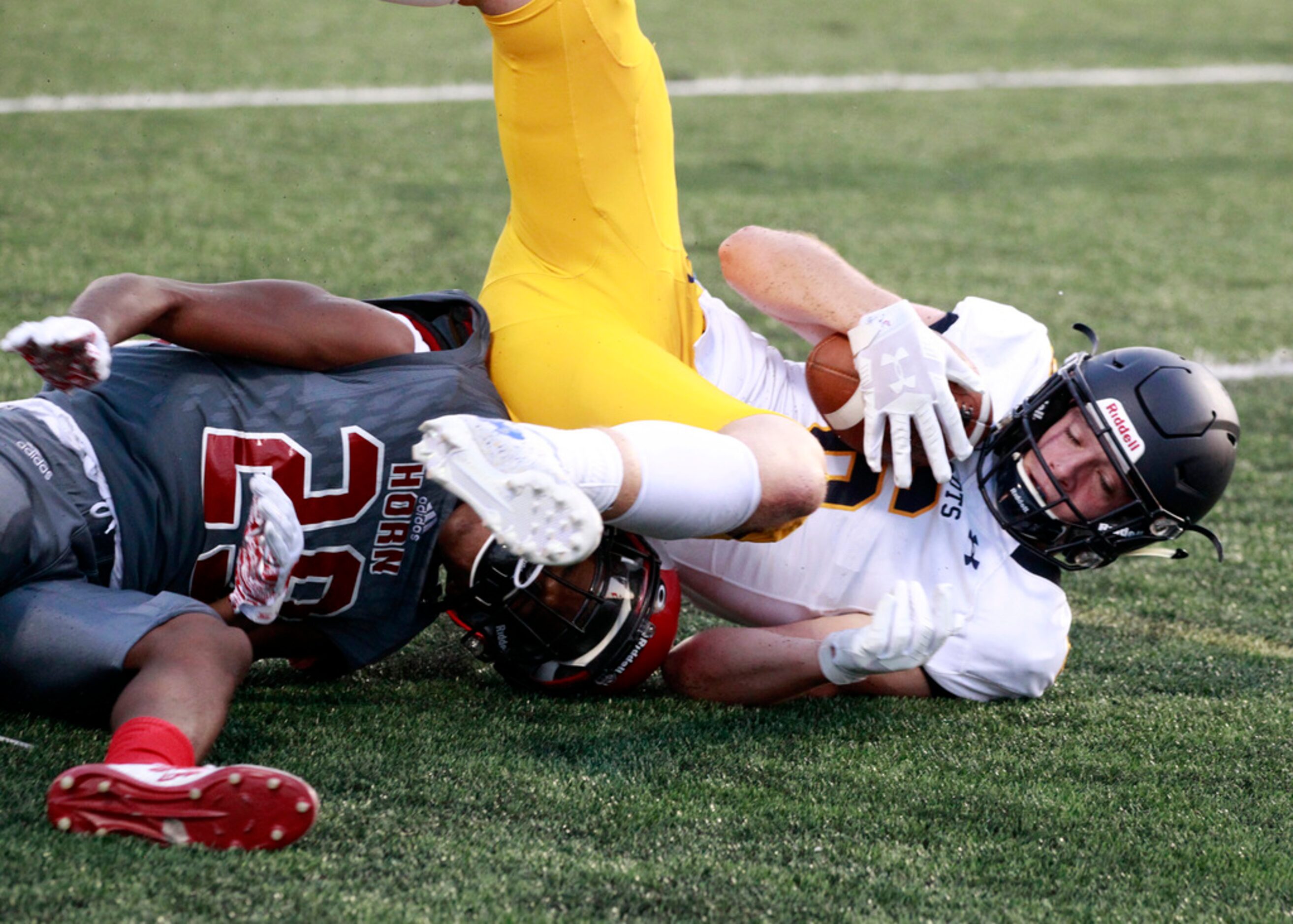 Highland Park's Paxton Anderson (6) rolls over John Horn defender Andrew Gaines (29) for a...