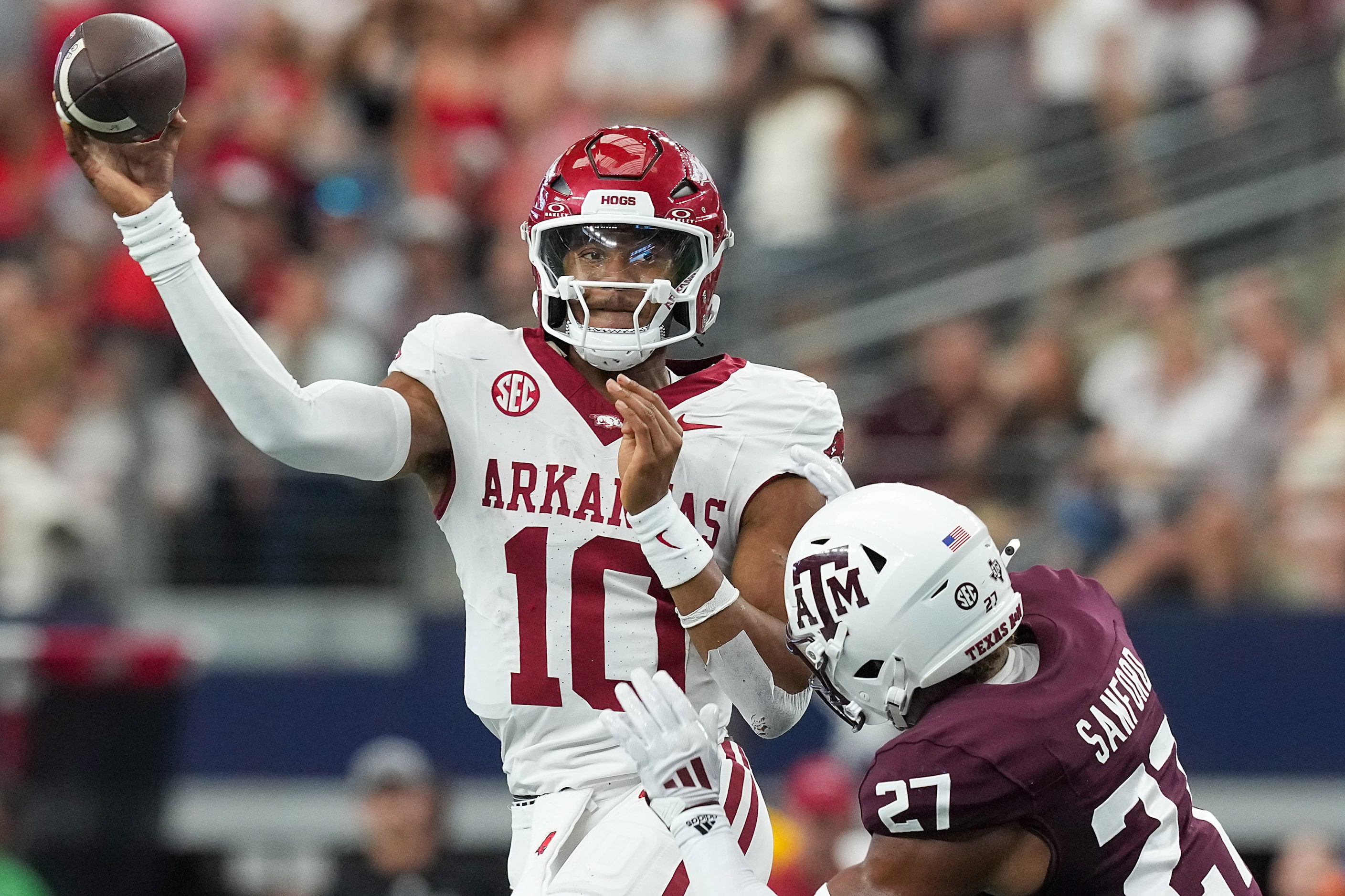 Arkansas quarterback Taylen Green (10) throws a pass under pressure from Texas A&M...