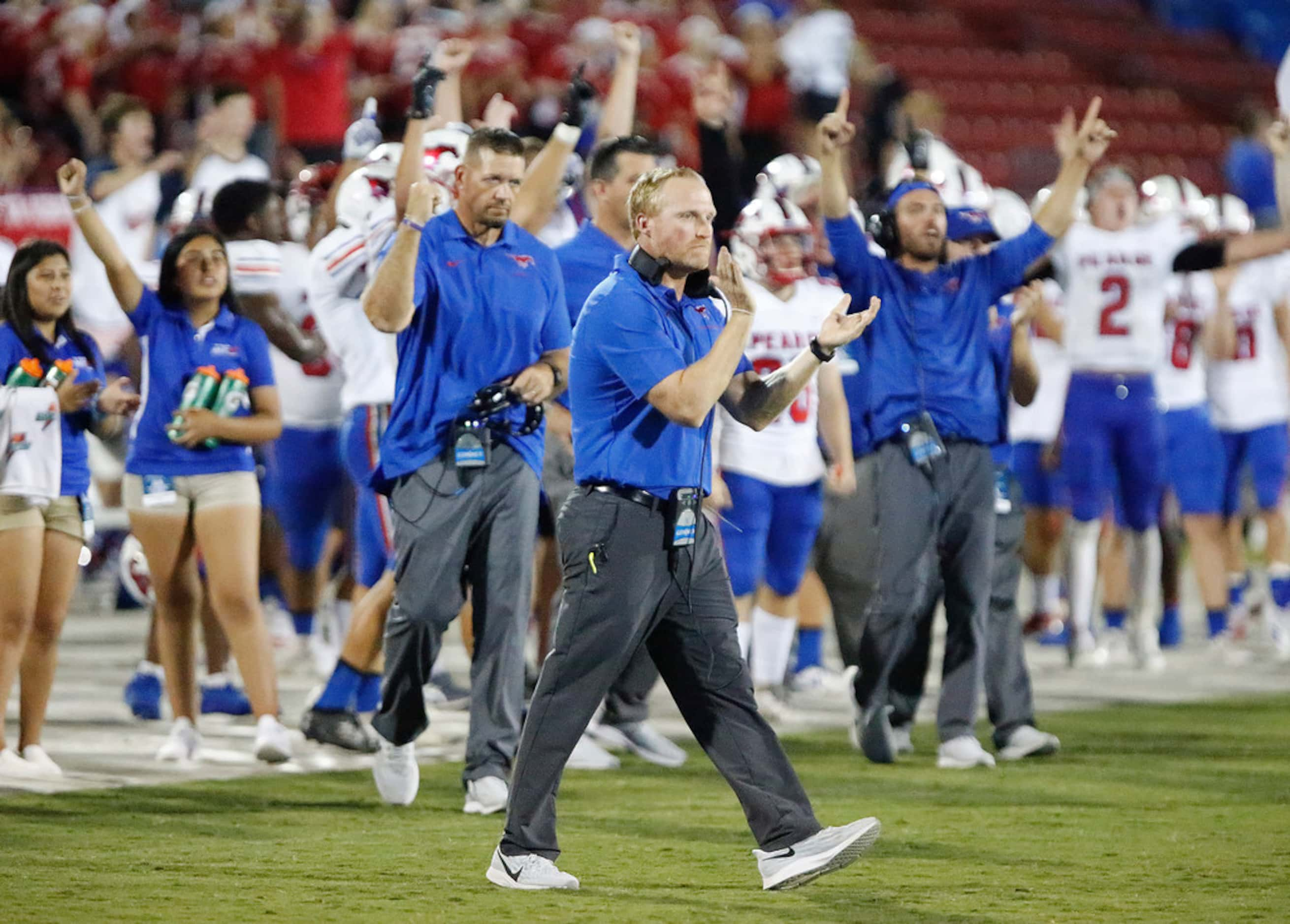 Richardson Pearce High School head coach David Collins (center) leads the sideline in...