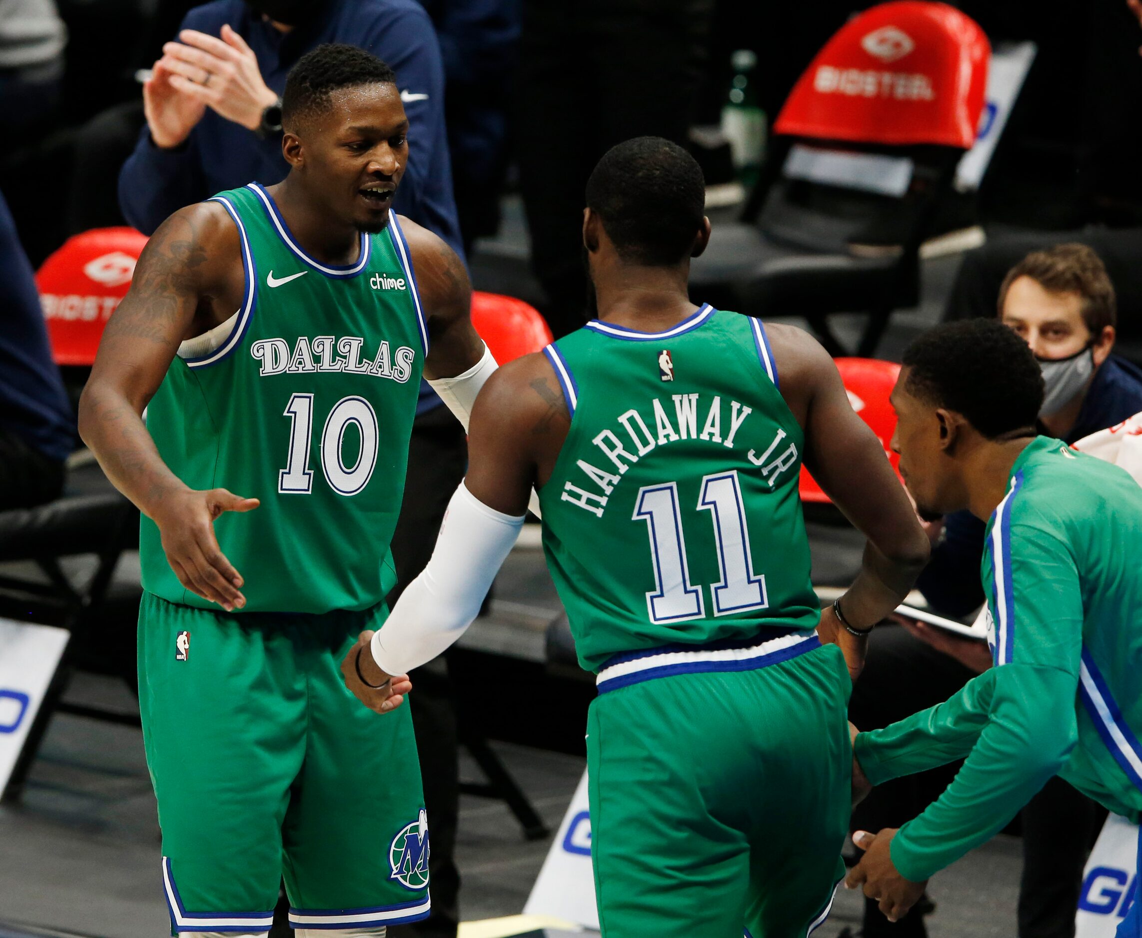 Dallas Mavericks forward Dorian Finney-Smith (10) congratulates Dallas Mavericks guard Tim...