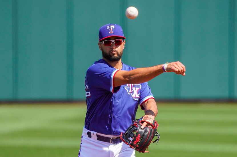 Texas Rangers shortstop Isiah Kiner-Falefa makes a throw during the first inning of a spring...