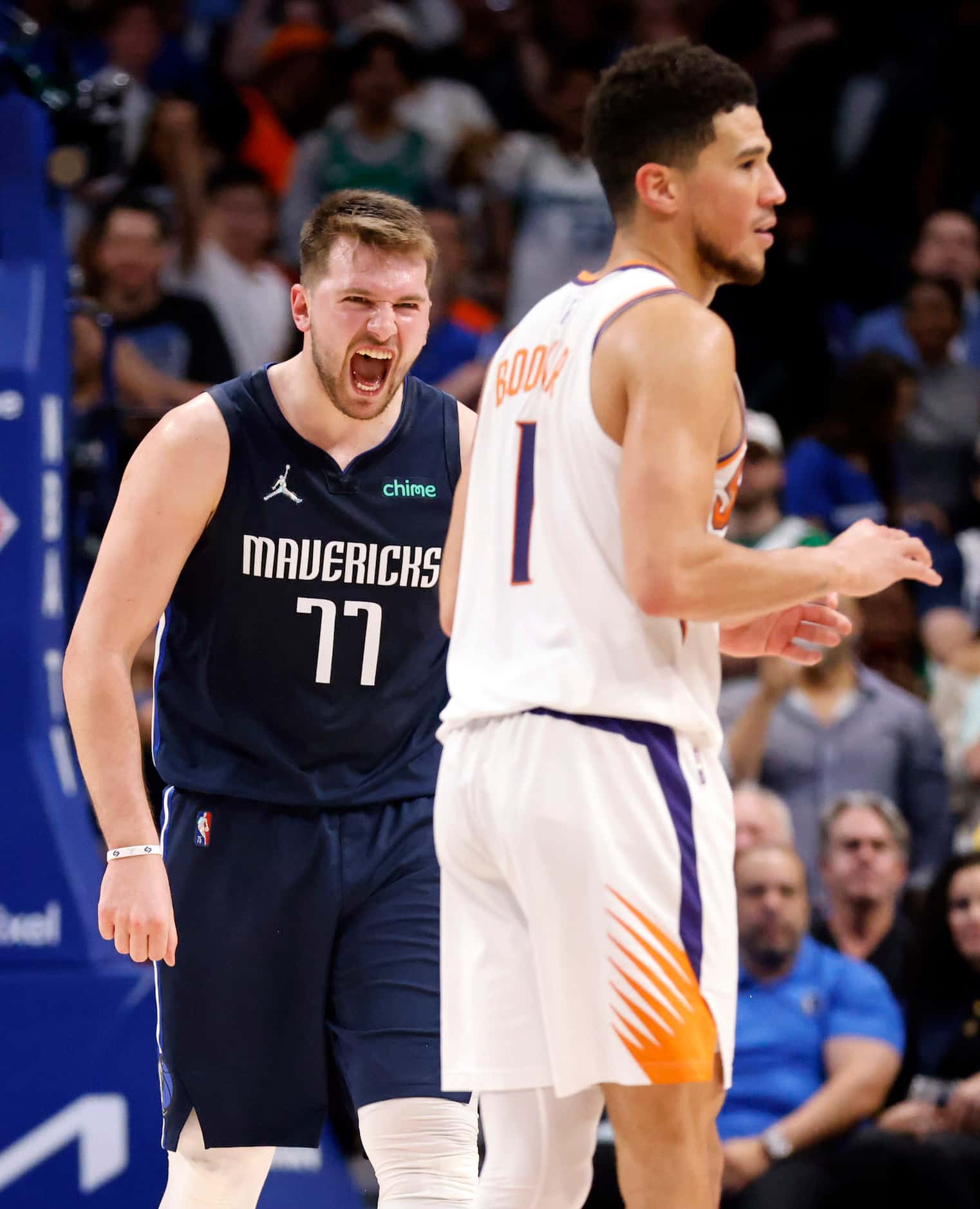 Dallas Mavericks guard Luka Doncic (77) reacts toward Phoenix Suns guard Devin Booker (1)...