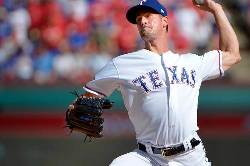 Texas Rangers starting pitcher Cole Hamels throws during the first inning against the...