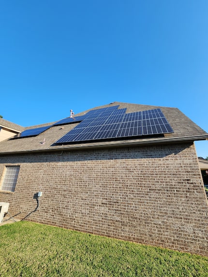 Solar panels on Tom Seng's rooftop. The southeast facing panels provide him power from about...