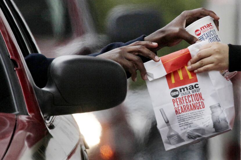 In this Jan. 22 file photo, a customer grabs lunch at a McDonalds drive-through in Chicago.