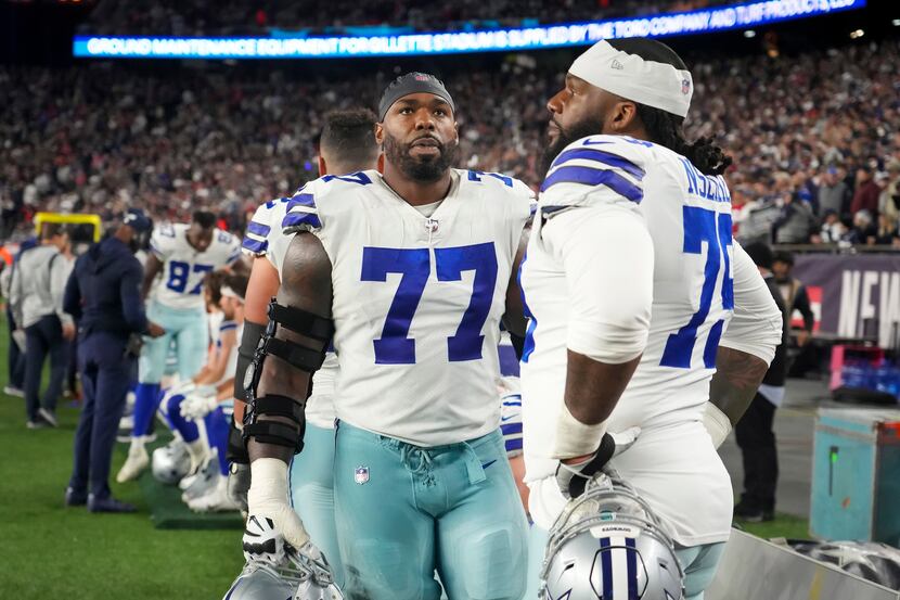 Dallas Cowboys offensive tackle Tyron Smith (77) looks up at the scoreboard as he stands on...
