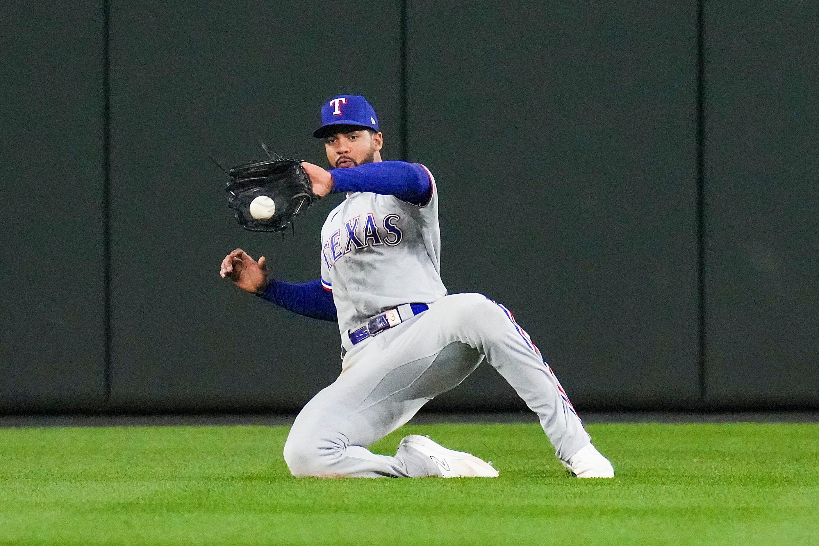 Texas Rangers center fielder Leody Taveras makes a sliding catch on a line drive by...