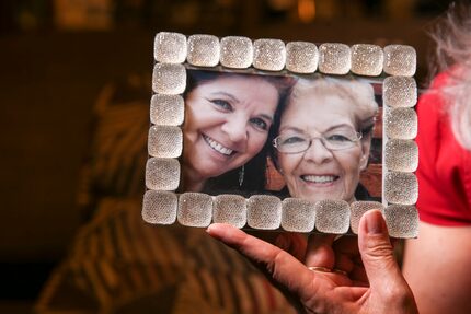 Rebecca Payan holds a photograph of her and her mother, Ofelia Reyes. Relatives are helping...