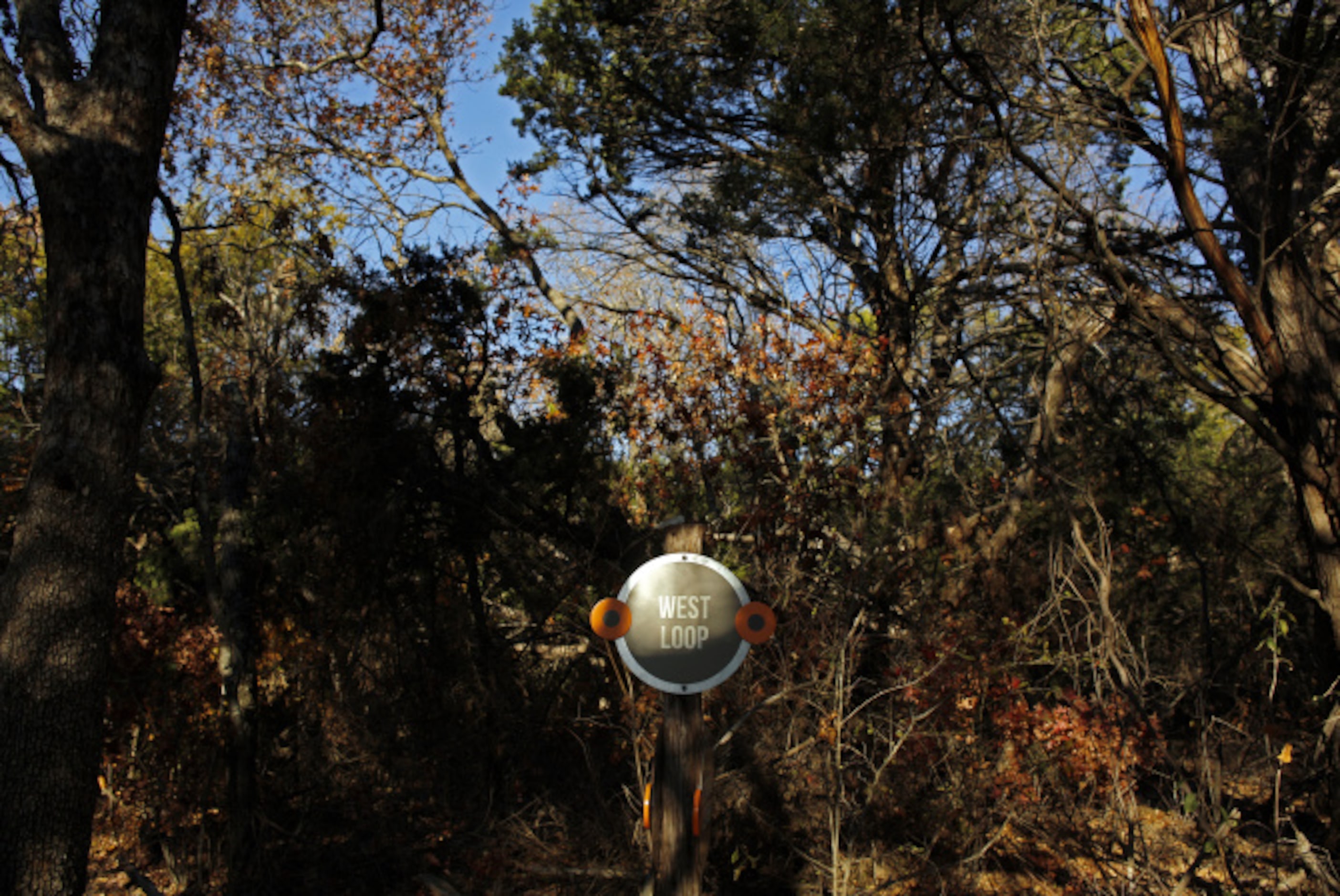 A sign stands at a trail fork at the Dogwood Canyon Audubon Center at Cedar Hill.