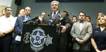  Ron Pinkston (at lectern), president of the Dallas Police Association, was joined by...