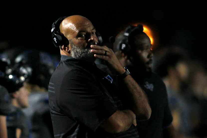 Hebron football coach Brian Brazil glances to the scoreboard during first-quarter action...