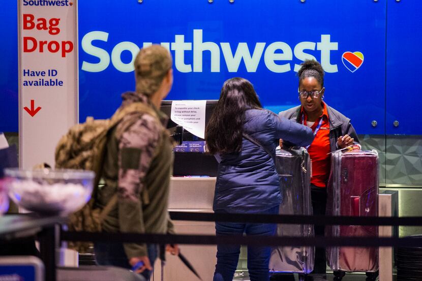 Southwest Airlines employees check in passengers at Love Field Airport on Jan. 3, 2019 in...