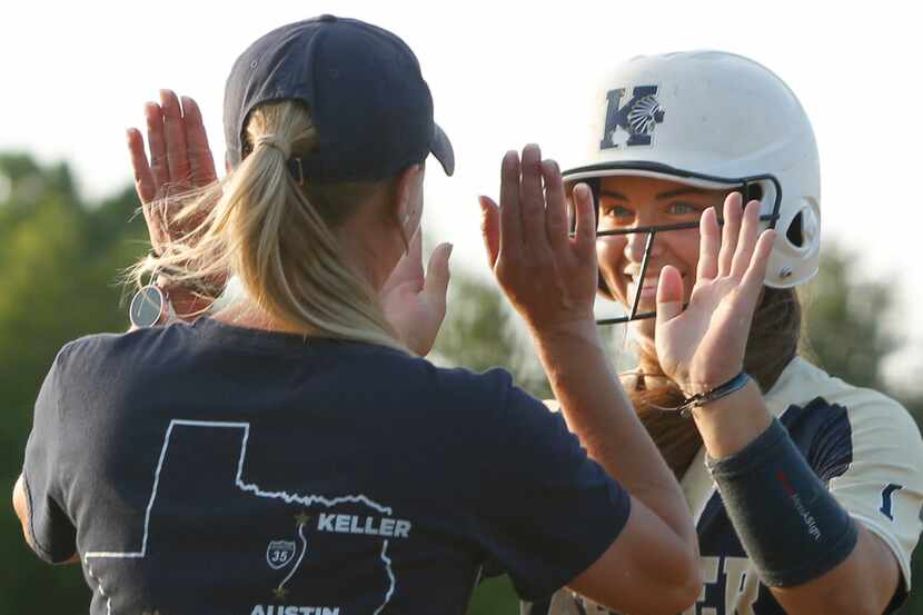 Keller baserunner Alexa Longeliers (9) was all smiles as she receives congratulations from...