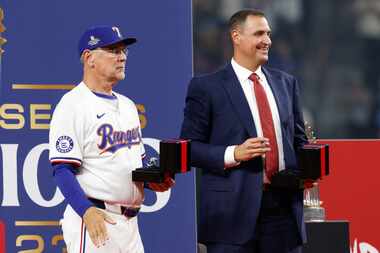 Texas Rangers manager Bruce Bochy and general manager Chris Young stand on stage with the...