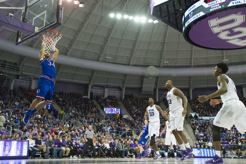 FORT WORTH, TX - FEBRUARY 6: Perry Ellis #34 of the Kansas Jayhawks catches an alley-oop...
