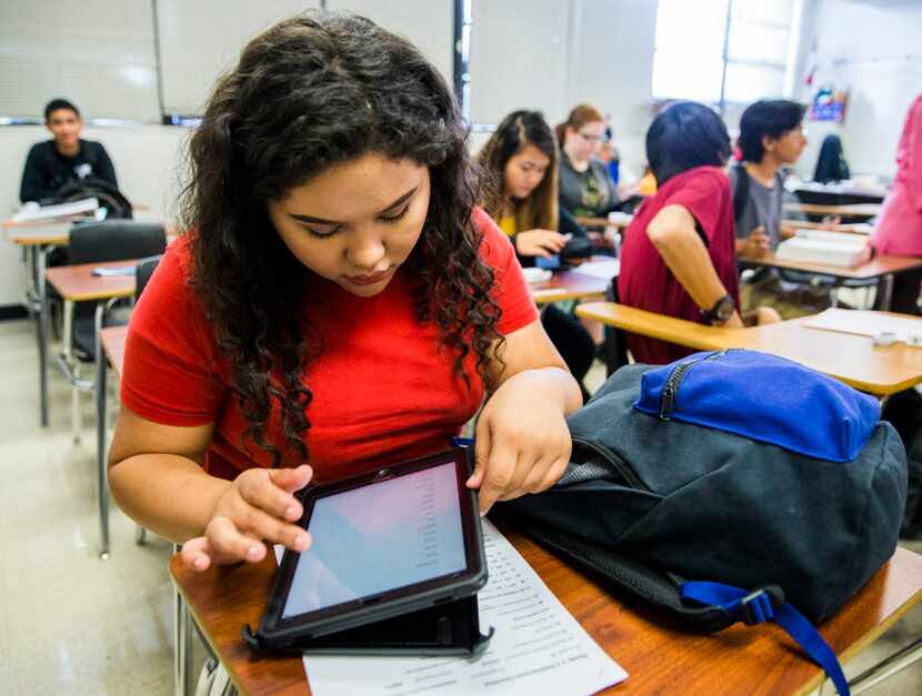 Claudia Hernandez works on her school district-issued iPad at Garland High School. The...