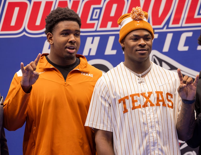 Defensive tackle Alex January (left) and defensive end Colin Simmons take photos after...